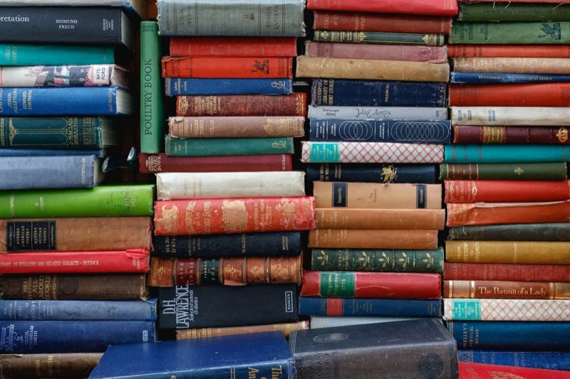 Books illustrating a 404 Media article about AI-generated fiction